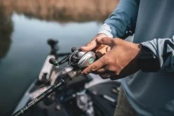 Quantum Energy S3 Baitcasting Reel -Unique Fishing Store energy bc reel and rod closeup lifestyle